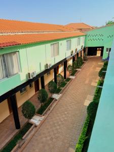 an overhead view of a building with a pathway and trees at MAG Palace Hotel in Bissau