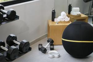 a gym with an exercise ball and dumbbells on the floor at Fiesta Inn Monterrey la Fe in Monterrey +48 photos