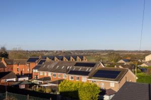 a group of houses with solar panels on their roofs at Hallbank Hideout in Amble
