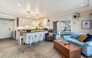 a kitchen and living room with a couch and a table at Riverfront Cottage - Steam Room & Pet Friendly in Bend