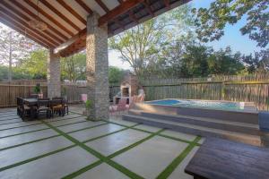 a patio with a table and a swimming pool at Edjami River View in Marloth Park