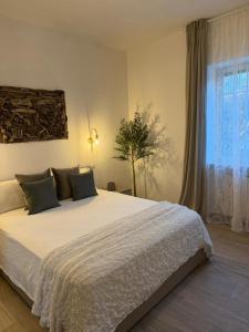 a bedroom with a large bed and a window at CasadiCampo in Scauri