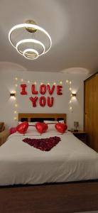 a bedroom with a bed with a sign that says i love you at Luxury Studio Pool & Free Private Beach, Close to Airport in Hurghada
