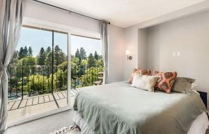 a bedroom with a bed and a large window at Riverview Pet Friendly Condo in Downtown Bend in Bend
