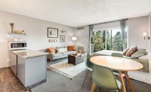 a living room with a table and a couch at Riverview Pet Friendly Condo in Downtown Bend in Bend