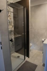 a bathroom with a glass shower with a toilet at Chatka Bratka in Kletno
