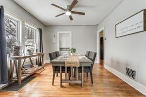 a dining room with a table and a ceiling fan at 8 Mi to Micron Technology! Walkable Phoenix Gem in Phoenix