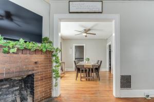 a dining room with a brick fireplace and a ceiling fan at 8 Mi to Micron Technology! Walkable Phoenix Gem in Phoenix +21 photos