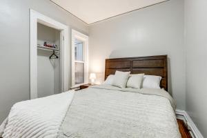a white bedroom with a large bed with white pillows at 8 Mi to Micron Technology! Walkable Phoenix Gem in Phoenix