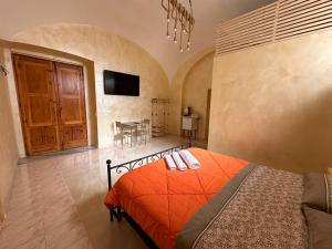 a bedroom with a bed and a dining room at Dea in Maddaloni +8 photos