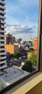 a view of a city from a window at Monoambiente céntrico 02 in Asunción