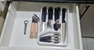 a drawer filled with utensils in a cabinet at Monoambiente céntrico 02 in Asunción
