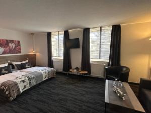 a hotel room with a bed and a couch at Hotel Bergschlößchen in Pockau +54 photos
