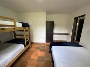 a room with two bunk beds and a tiled floor at Finca Sol y Luna in San Gil +44 photos
