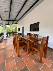 a dining room with a wooden table and chairs at Finca Sol y Luna in San Gil