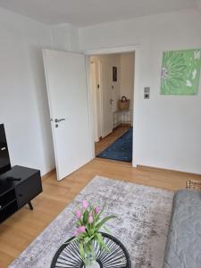 a living room with a vase of flowers on a table at Solarhaus Guxhagen in Guxhagen