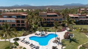 an aerial view of a resort with a pool and palm trees at Relaxing Beachfront Condo in San José del Cabo
