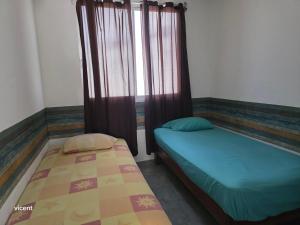 a bedroom with two beds and a window at Nómadas in San Luis