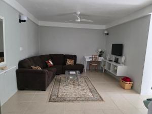 a living room with a couch and a table at Garden View Apartments in Roseau