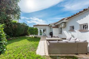 a backyard with a couch and a table at Cozy Villa With Pool In Marbella Nueva Andalucia in Marbella