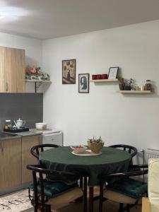 a kitchen with a table and chairs in a room at Mira in Čajetina +1 photo