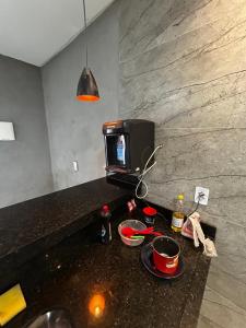 a kitchen counter with a tv and bowls on it at Sobrado Oliveira in Goiânia +6 photos