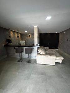 a living room with a couch and a table at Sobrado Oliveira in Goiânia