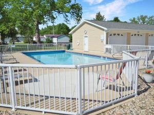a swimming pool with a white fence around it at 84 Rohr 7B in Arnolds Park