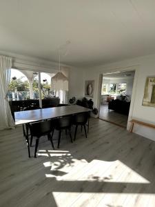 a dining room with a table and chairs in a living room at Sweet Home in Aarhus