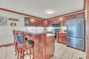 a kitchen with wooden cabinets and a stainless steel refrigerator at 84 Rohr 7B in Arnolds Park