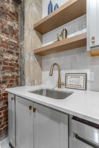 a kitchen with a sink and a brick wall at Park Hotel 1BR Suite 310 in Chattanooga