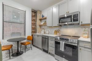 a kitchen with white cabinets and a stove top oven at Park Hotel 1BR Suite 310 in Chattanooga