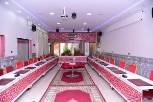 a conference room with red chairs and a table at Riad Asma in Taroudant