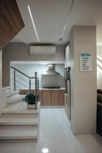 a kitchen with stairs and a kitchen with a counter at Natalie Aqua villa heated pool 3BD DeadSea in Al Kafrayn