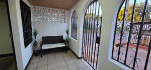 a hallway with wrought iron gates and a chair at Casa Petunia, Managua in Managua