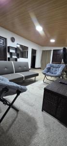 a living room with couches and a couch and chairs at Casa Petunia, Managua in Managua