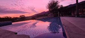 a reflection of a sunset in a swimming pool at Finca Hotel San Sebastian in La Paloma