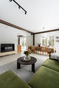 a living room with a couch and a table at Charming Seaside Country Cottage in Myza Lakhetaguze