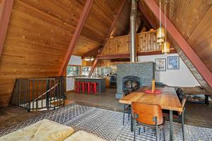 a living room with a table and a fireplace at Snowball House in Government Camp