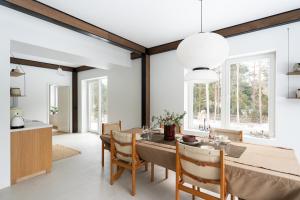 a dining room with a table and chairs at Charming Seaside Country Cottage in Myza Lakhetaguze