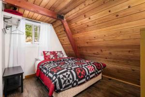a bedroom with a bed and a wooden wall at Snowball House in Government Camp