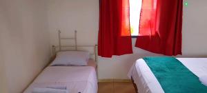 a small room with two beds and a window at Spin world Clube São Roque in São Roque +45 photos