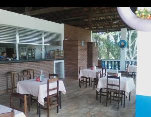a dining room with tables and chairs in a restaurant at Spin world Clube São Roque in São Roque