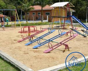 a playground with colorful slides and a play equipment at Spin world Clube São Roque in São Roque