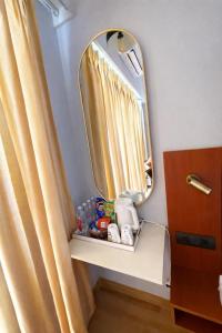 a bathroom with a mirror next to a curtain at Sunhaven Studio I Work & Leisure Stays I Near Expo Mart in Greater Noida
