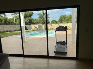 a view of a sliding glass door with a view of a pool at Villa Vazquez in Capiatá