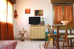 a living room with a tv and a table at A casa di Nonna Maria in Marsala