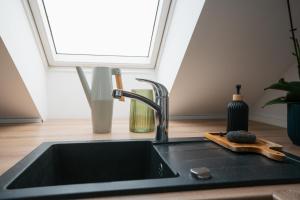 a kitchen counter with a sink and a window at Premium Design Loft - Old Town in Košice