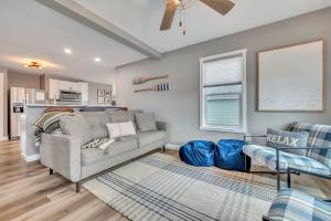 a living room with a couch and a table at Okoboji BLUEtiful Cottage in Arnolds Park