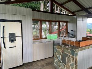 a kitchen with a counter and a refrigerator in it at Finca Hotel San Sebastian in La Paloma